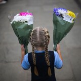 A girl holding flowers.