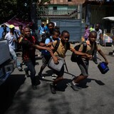 Children run towards their parents at the end of their school day as police carry out an operation against gangs in the Bel-Air area of Port-au-Prince, Haiti, on March 3. (Odelyn Joseph/Associated Press)