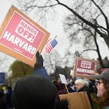 Demonstrators rally on Cambridge Common in a protest on April 12 calling on Harvard leadership to resist interference at the university by the federal government in Cambridge, Mass. The Trump administration's latest salvo directed at the school was quickly met with a lawsuit. (Nicholas Pfosi/Reuters)
