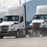 Heavy-duty trucks on a road.