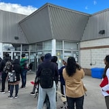 A lineup outside of the Brampton location of BLS International.
