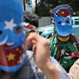 
Muslim students wearing masks with the colors of the pro-independence East Turkistan flag attend a rally outside the Chinese Embassy in Jakarta, Indonesia, earlier this year. The students staged the rally to call for an end to alleged oppression against the Muslim Uyghur ethnic minority in Xinjiang.