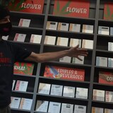A man displays products for sale in a cannabis store near Sudbury, Ont. Health Canada is in the process of updating the rules that govern the industry, and Canada's competition watchdog had some suggestions for the health agency on Friday. (Erik White/CBC)