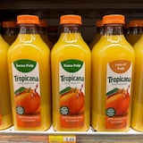 Containers of Tropicana orange juice displayed on a grocery store shelf.