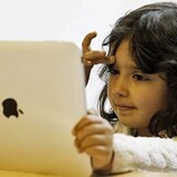 Screens themselves are not inherently bad but they displace activities that are key to child development, pediatricians say. (Luke MacGregor/Reuters)