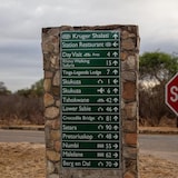A sign with directions to various locations in a South African national park.
