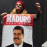A woman holds a poster with an image of ousted Venezuelan president Nicolás Maduro during a government-organized rally in Caracas, Venezuela, on Sept. 23. New charges will be filed today against Maduro in the U.S. 