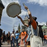 Une manifestante joue du tambour. 