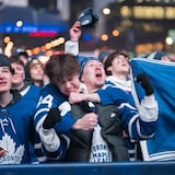 Fans watch the Toronto Maple Leafs play against the Boston Bruins at a tailgate outside Scotiabank Arena on Wednesday night. 