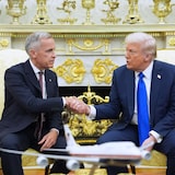 Prime Minister Mark Carney shakes hands with U.S. President Donald Trump at the start of a meeting in the Oval Office in the White House in Washington, D.C., on Tuesday.
