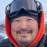 A man, smiling.