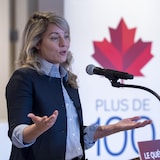 Mélanie Joly behind a microphone.