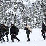 Finnish border guards escort migrants at the Raja-Jooseppi checkpoint, which will be the last of Finland's border crossings with Russia to close as a result of a recent increase of migrant arrivals at Finland's eastern border. (Emmi Korhonen/Lehtikuva/The Associated Press)