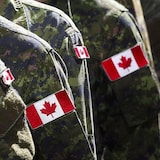 Closeup of the Canadian flag on soldiers' uniforms.