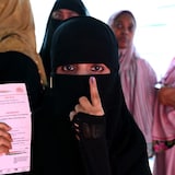 A Muslim woman shows her inked finger after casting her ballot in India's general election, in Hyderabad on May 13. 
