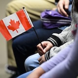 A young new Canadian holds a flag as she takes part in a citizenship ceremony on Parliament Hill in Ottawa on Wednesday, April 17, 2019, to mark the 37th anniversary of the Canadian Charter of Rights and Freedoms. A report by the Royal Bank says a slowdown of immigration to Canada due to the COVID-19 pandemic threatens to derail what it says has been a major source of economic growth at least temporarily. THE CANADIAN PRESS/Sean Kilpatrick
