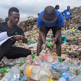 Volunteers from Green Africa Youth Organization and End Plastic Pollution Uganda examine branded plastic waste and record brand audit data in Kampala, Uganda. 