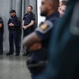Canada Border Services Agency officers listen during an announcement about a seizure of opium in 2022. Members could start striking next month. 