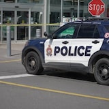 An Ottawa Police Service car sits parked outside an Ottawa grocery store after a woman was stabbed on Wednesday.