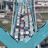 Transport trucks cross the Ambassador Bridge connecting Windsor, Ont., to Detroit. 