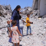 Nisreen Ramadan Abu Kashif, 48, tries to find food with four of her nine children in Khan Younis, southern Gaza, on June 17, 2024. 