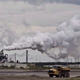 A dump truck works near the Syncrude oilsands extraction facility near Fort McMurray, Alta., in 2014. The Impact Assessment Act allows federal regulators to consider how a development would affect climate change mitigation, social impacts and gender parity, as well as its cumulative effects when combined with other projects. 