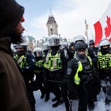 Demonstrators gather and wave flags as part of a convoy-style protest in Ottawa on April 30. Organizers tied to the Freedom Convoy, which caused gridlock and other disruptions in the capital last winter, have said they're planning protests for Ottawa throughout the summer.