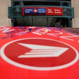 The exterior of a Canada Post office with a closeup of a mailbox in front of it.