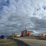 A road leading to a few buildings in a remote area of Northern Quebec.