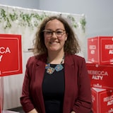 Une femme se tient devant des pancartes à son nom pour le Parti libéral du Canada, à Yellowknife, aux Territoires du Nord-Ouest, le 28 avril 2025.