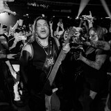 Robert Trujillo wearing the medallion whilst walking through the crowd of fans.