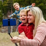 A mother and her two children take a 'selfie' in this 2020 file photo. Nearly half of parents admit they spend too much time on their smartphones, according to new data from Pew Research Centre. 
