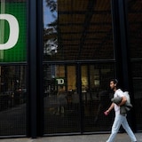 A man walks past the TD Bank in the Bay Street Financial District in Toronto. A former TD Bank employee falsified documents to open dozens of accounts and provided concierge-like services to help cash flow across borders, Bloomberg News reported on Monday.