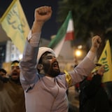 Iranians celebrate in the streets of Tehran after Iran's air attack on Israel.