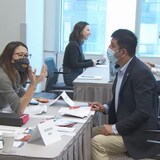 At the Toronto Refugee Hiring Event in Metro Hall, some refugees received a job offer on the spot, others got a second interview, and still others were flagged for future job opportunities. Job seekers will also had access to a 'coaching corner,' pictured here, where they were able to receive interview tips from employment consultants. (CBC)