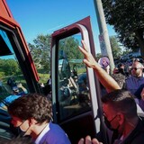 RCMP security officers put their hands up to protect Liberal Leader Justin Trudeau from tossed gravel while leaving a campaign stop in London Ont., on September 6, 2021.