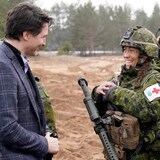 Canadian Prime Minister Justin Trudeau talks to soldier during a visit to the Adazi military base, northeast of Riga, Latvia, March 8, 2022.