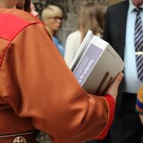 A picture of a man holding a report. 