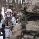 Civilian participants of a Kyiv territorial defense unit train in a forest.