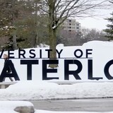 A person walks by the University of Waterloo sign on campus in Februrary 2020. The school is pulling 29 vending machines from campus that were found to have a form of facial recognition technology.