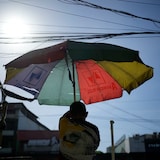 A vendor prepares his umbrella as hot days continue in Manila, Philippines. Sizzling heat across Asia and the Middle East in late April that echoed last year’s destructive swelter was made more likely because of human-caused climate change, a study found. 