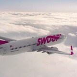 A plane cruises above the clouds.