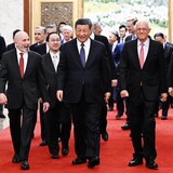 In this photo released by Xinhua News Agency, Chinese President Xi Jinping, center, walks with representatives from American business, strategic and academic communities at the Great Hall of the People in Beijing, March 27, 2024. (Shen Hong/Xinhua via AP)