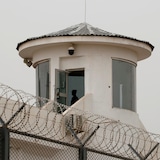 Un gardien de sécurité observe dans la tour de contrôle. 