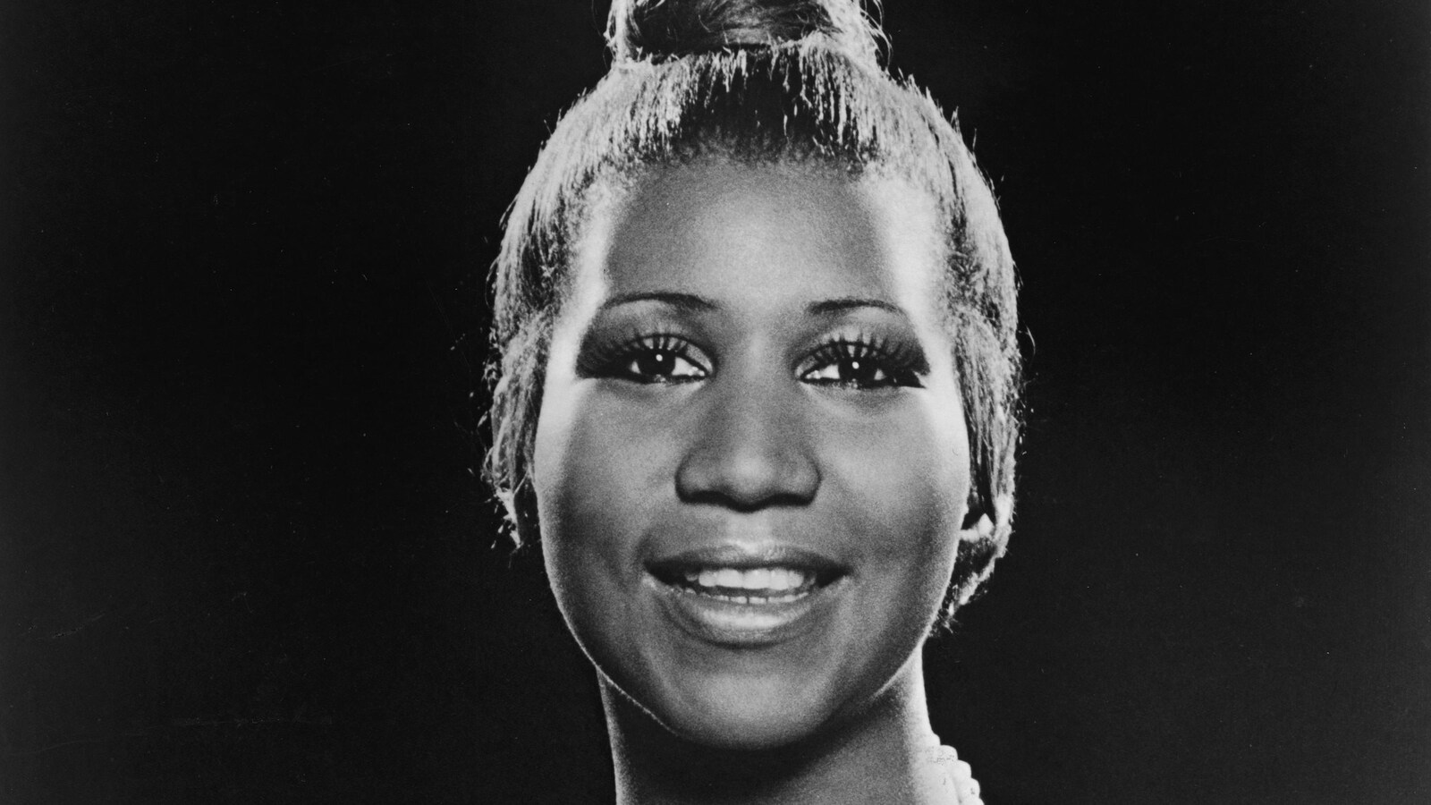 Aretha Franklin, alors âgée de 35 ans, sourit et regarde l'objectif.