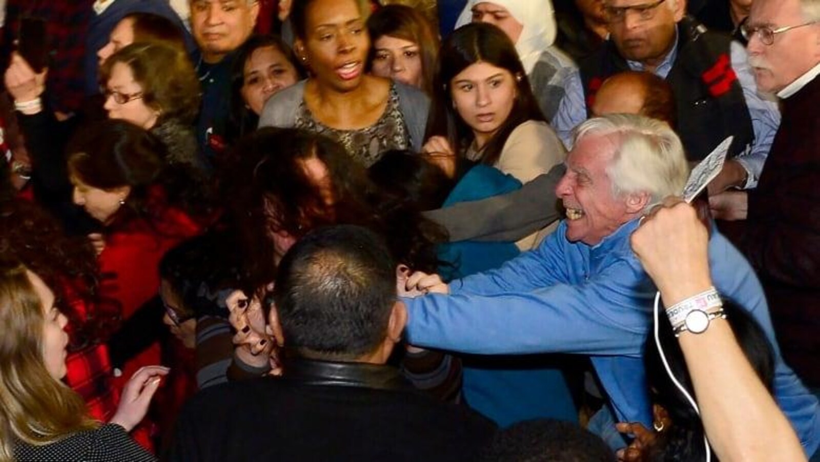 L'homme, à droite, semble attaquer une jeune femme autochtone, au centre, lors d'un rassemblement du Parti libéral du Canada, à Toronto le 4 mars dernier.