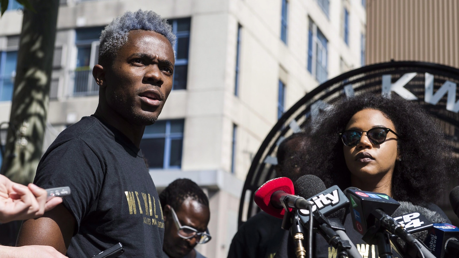 Rodney Diverlus, left, of Black Lives Matter Toronto, speaks at a news conference to discuss the Pride Parade controversy in Toronto on Thursday July 7, 2016. THE CANADIAN PRESS/Christopher Katsarov