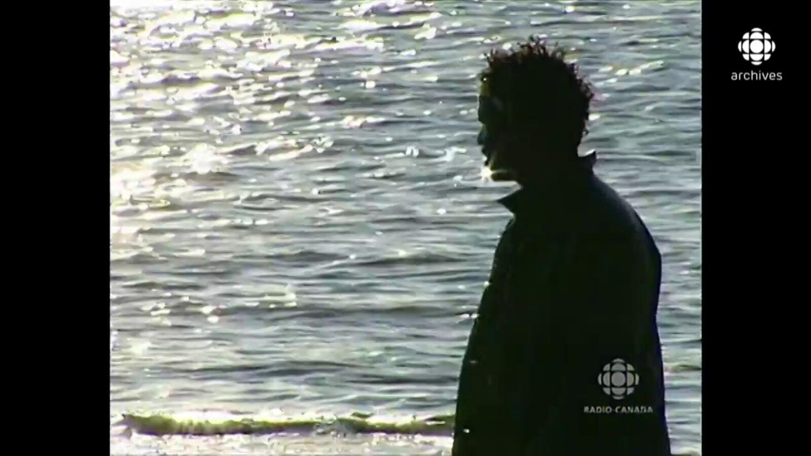 Boucar Diouf, à contre-jour, regardant l'horizon sur le bord du fleuve