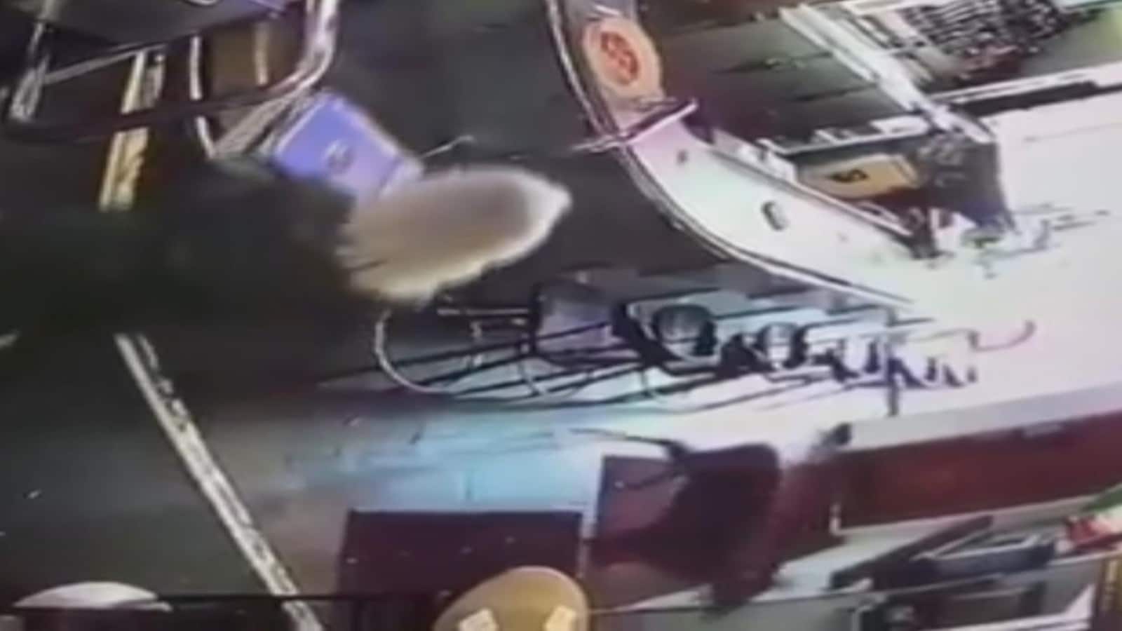 Photo d'un cerf qui marche devant un bar.