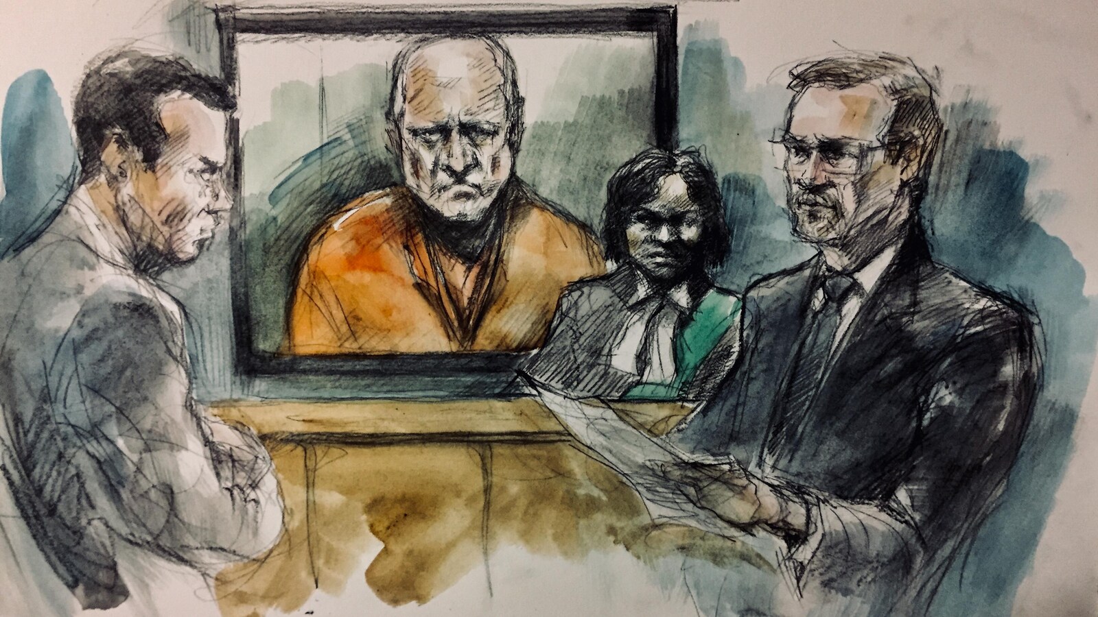 Image d'un homme dans un écran en tenue de prisonnier orange entouré de trois personnes.